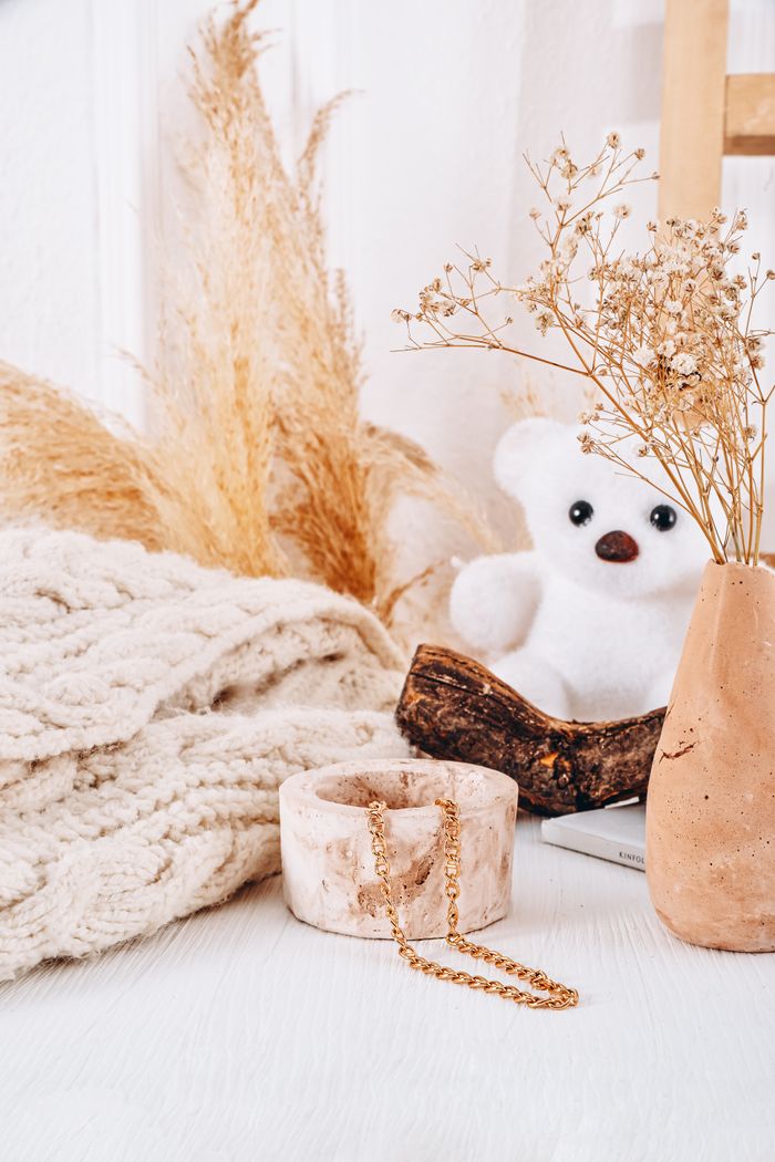 services-02 A cozy setup featuring a teddy bear, vase, and decor items with a warm, inviting tone.