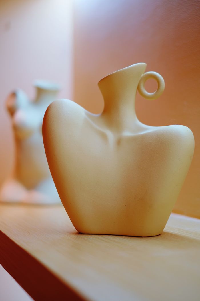 gallery-05 Contemporary ceramic vase with artistic design exhibited on a shelf, highlighting modern interior decor styles.